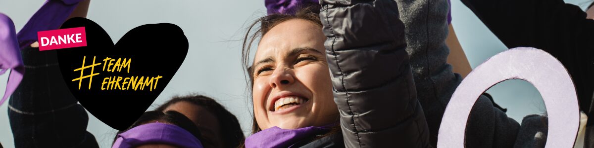 DSEE_Anerkennung_TeamEhrenamt_Frauentag_1200x300 Foto einer jungen Frau, die die Faust in einer Jubelpose hochhebt. Im Hintergrund sind weitere Arme mit lila Schleifen zu sehen. Darauf ein gezeichnetes Herz. Text: Danke #TeamEhrenamt